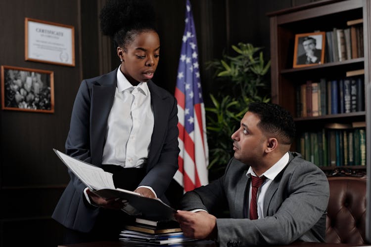 Lawyers In An Office Looking At Documents