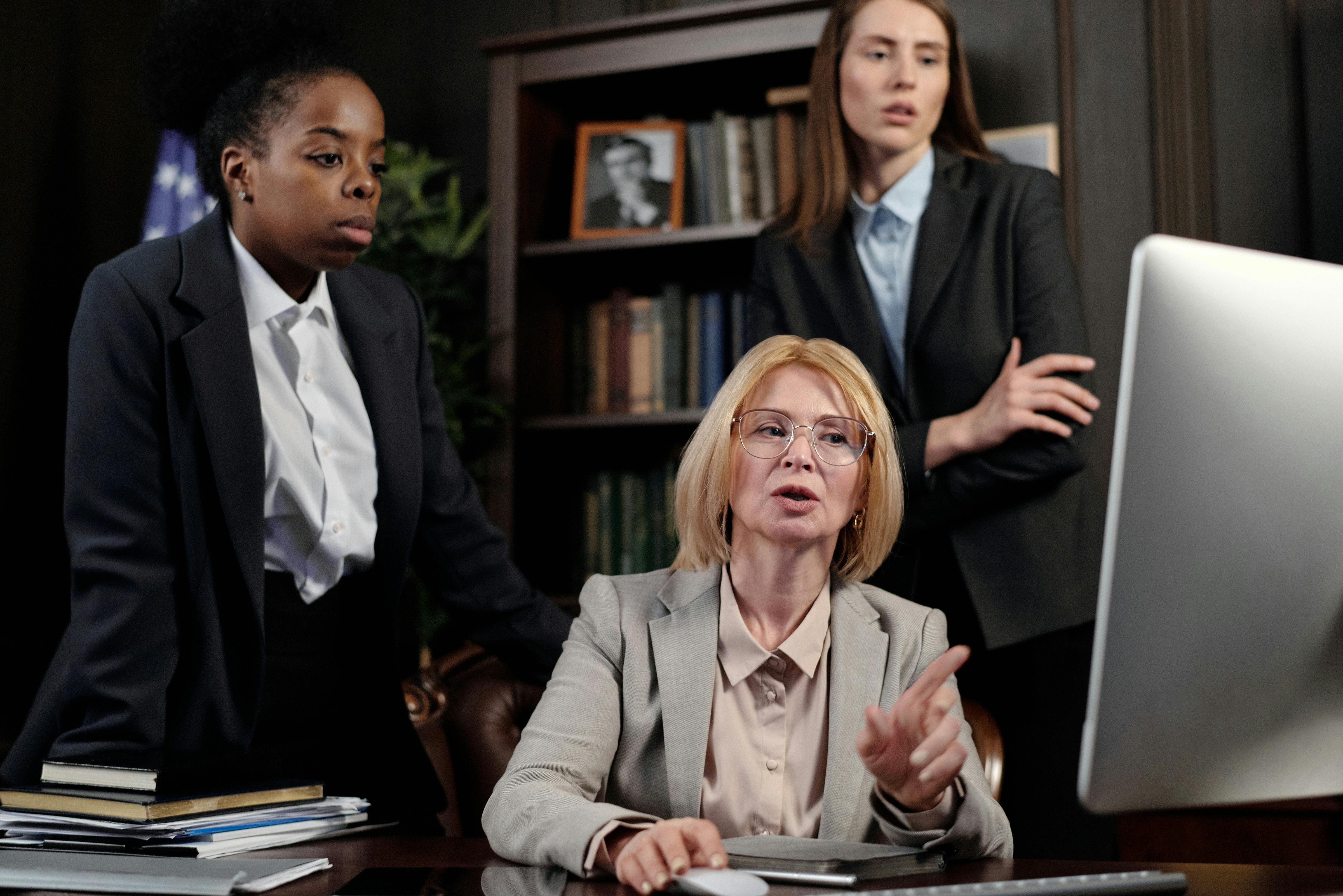 female lawyers in an office looking at a computer
