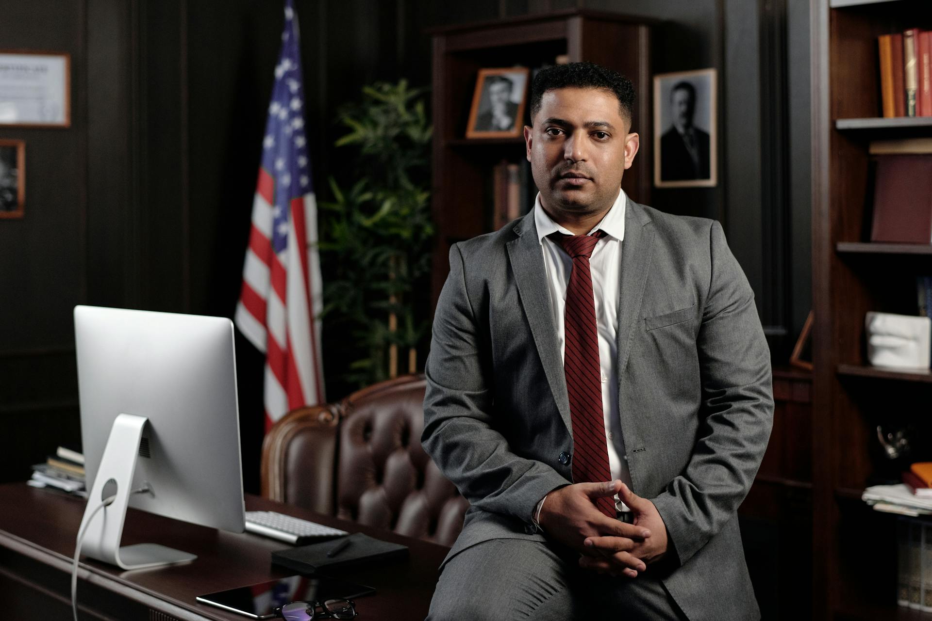 Businessman Sitting on his Desk and Looking at the Camera