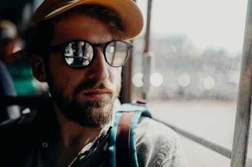 Man in Gray Jacket Wearing Black Sunglasses and Brown Hat