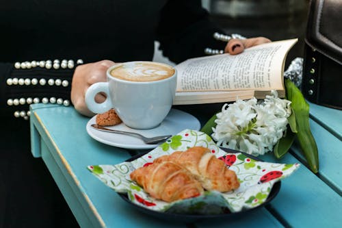 Cup of Coffee Beside a Plate with Bread