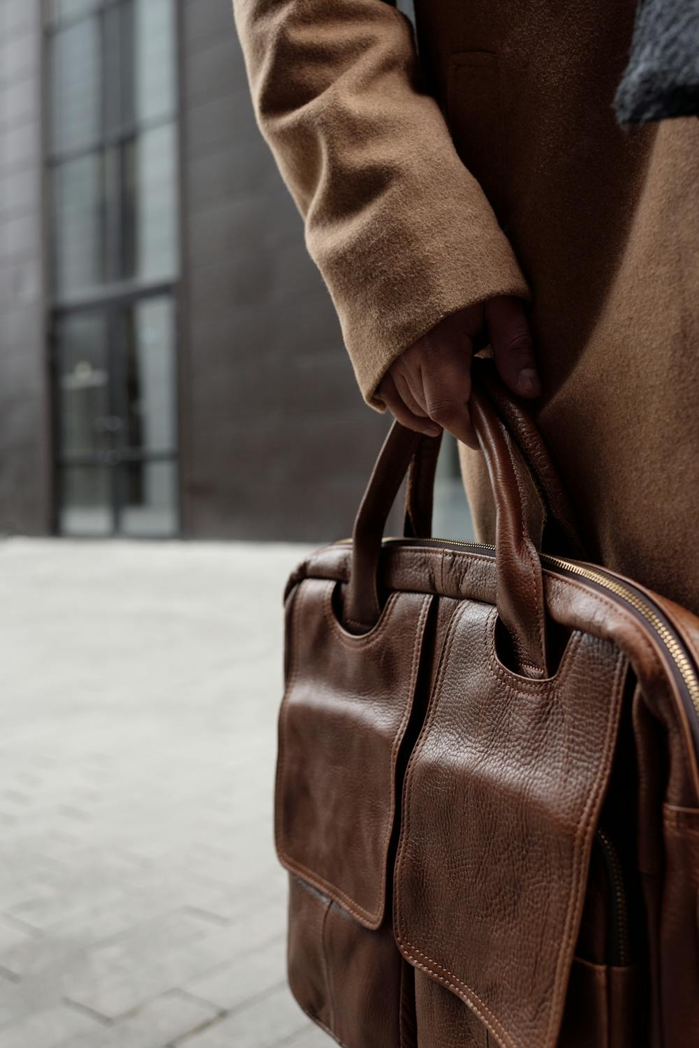 Brown Leather Handbag on White Textile · Free Stock Photo