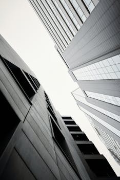 Stunning black and white photo of modern skyscrapers, capturing urban architecture from below.
