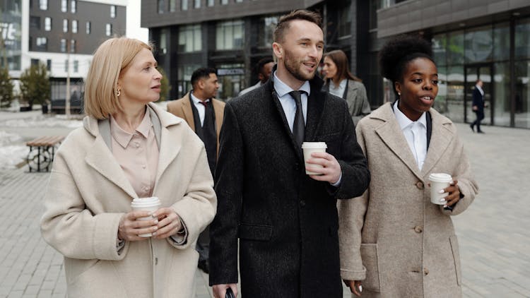 Coworkers Walking And Taking A Coffee Break