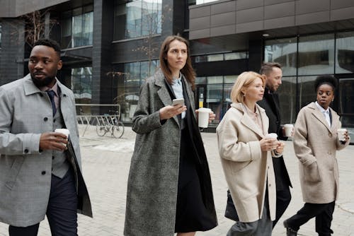 Free Coworkers Taking a Coffee Break and Walking Stock Photo