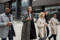 Coworkers Taking a Coffee Break and Walking