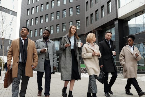 Free Coworkers Taking a Coffee Break and Walking Stock Photo