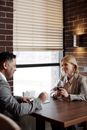 Man and Woman in Business Suits Sitting at Table