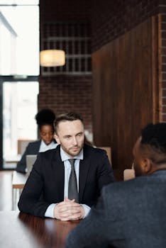 Professionals engaged in a business meeting in a contemporary café environment.