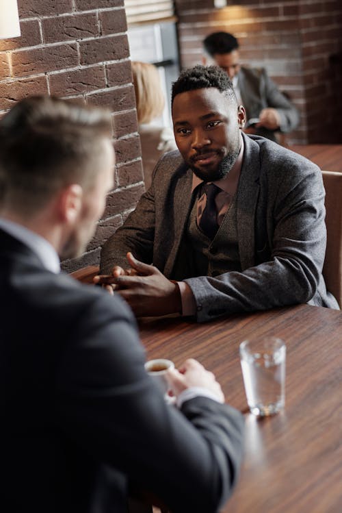Free Businessmen Having a Meeting at a Cafe Stock Photo