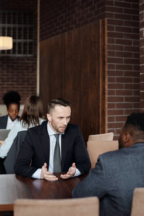 Free Businessmen Talking at a Cafe Stock Photo