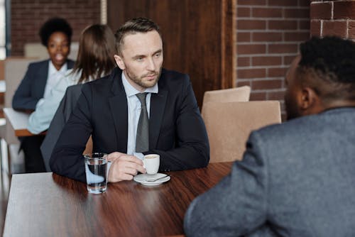 Free Businessmen Having a Meeting at a Cafe Stock Photo