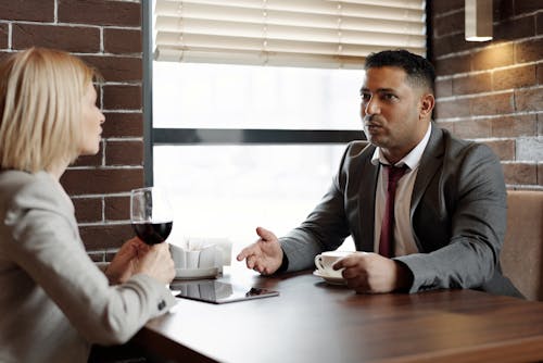 Free Coworkers Talking at a Cafe Stock Photo