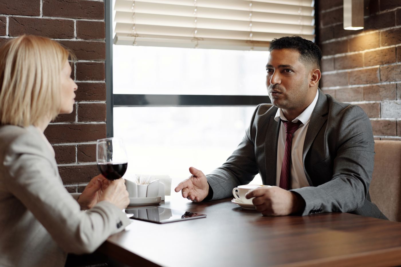 Two people talking over coffee