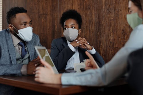 Free Business People Wearing Face Masks and Talking Stock Photo