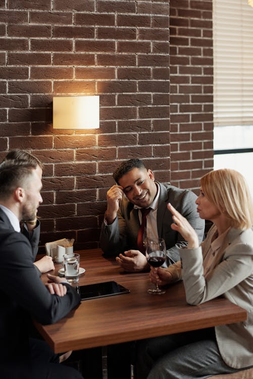 Free Coworkers Talking at a Cafe Stock Photo