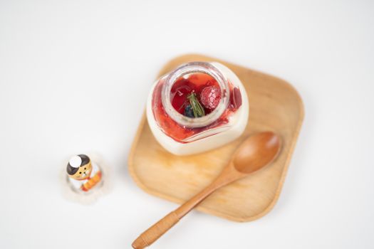 Healthy yogurt with berries on wooden saucer