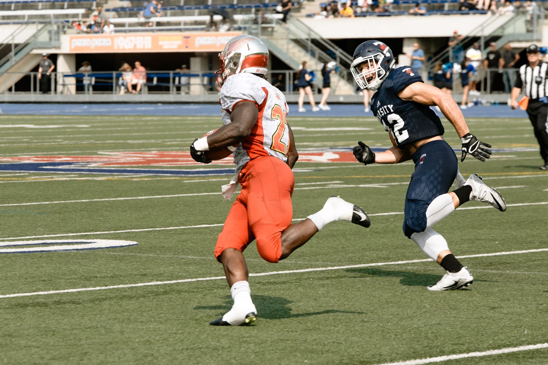 A winger sprinting through a marked exit gate after dribbling past a mannequin on a modern football field