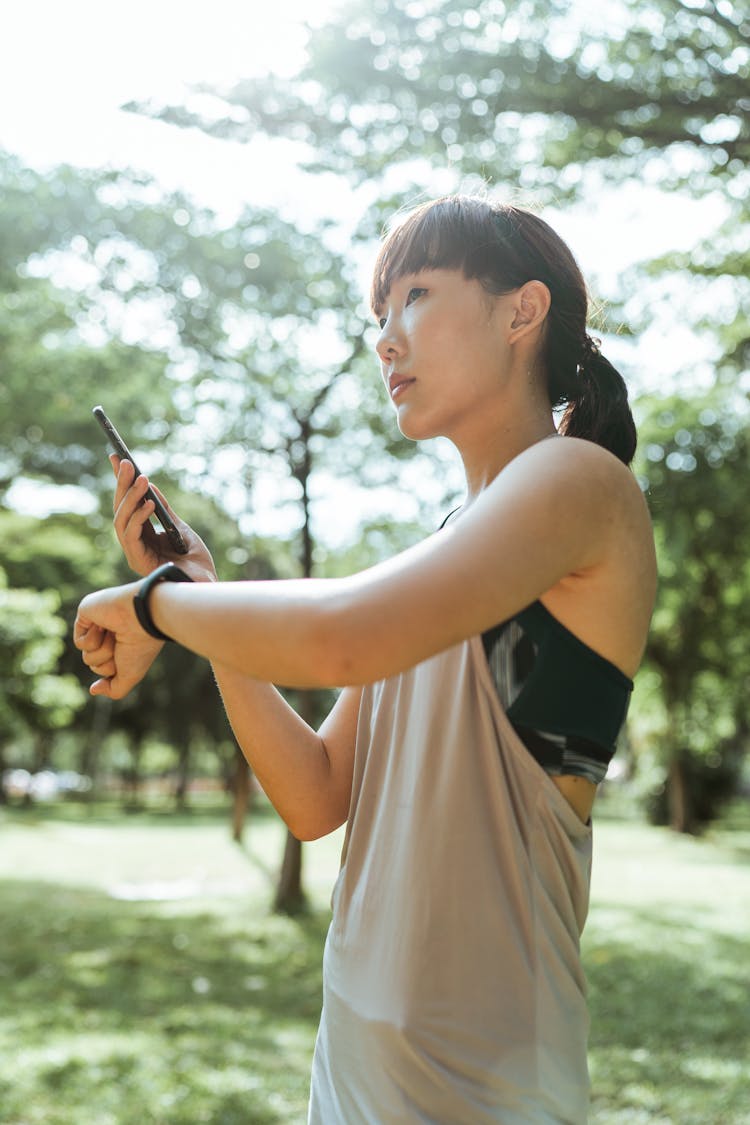 Calm Woman Checking Information About Training On Smartphone