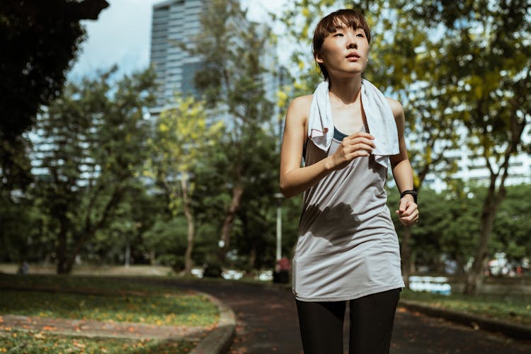 Young Asian Woman Jogging In Park