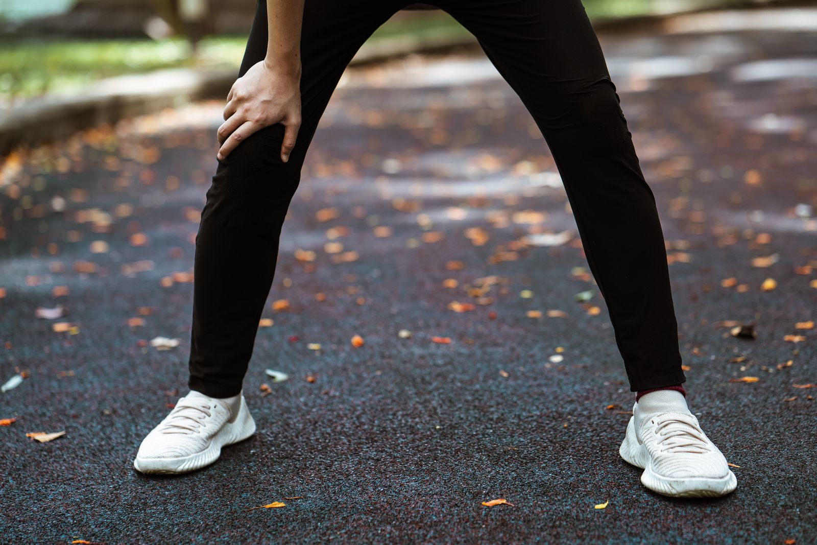 Woman outdoors adjusting a fitted arm sleeve before activity