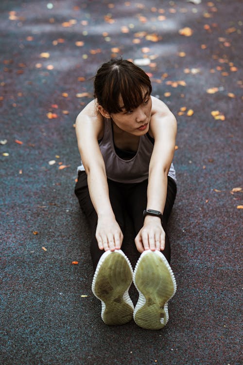 Focused Asian flexible woman doing stretch