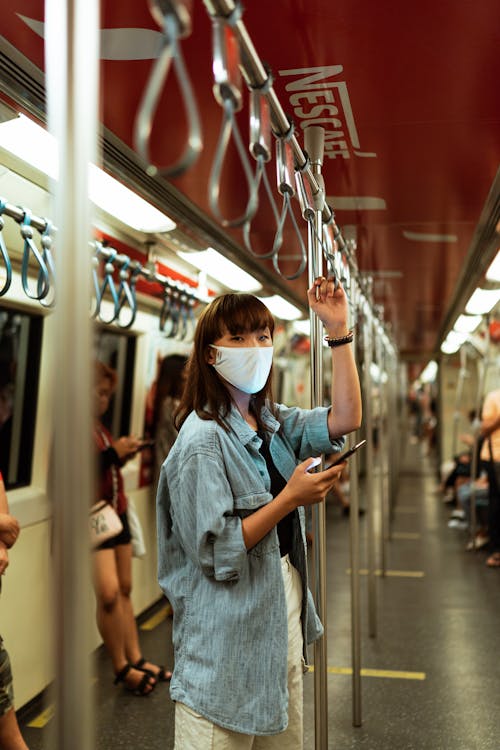 Woman Wearing a Face Mask on the Subway