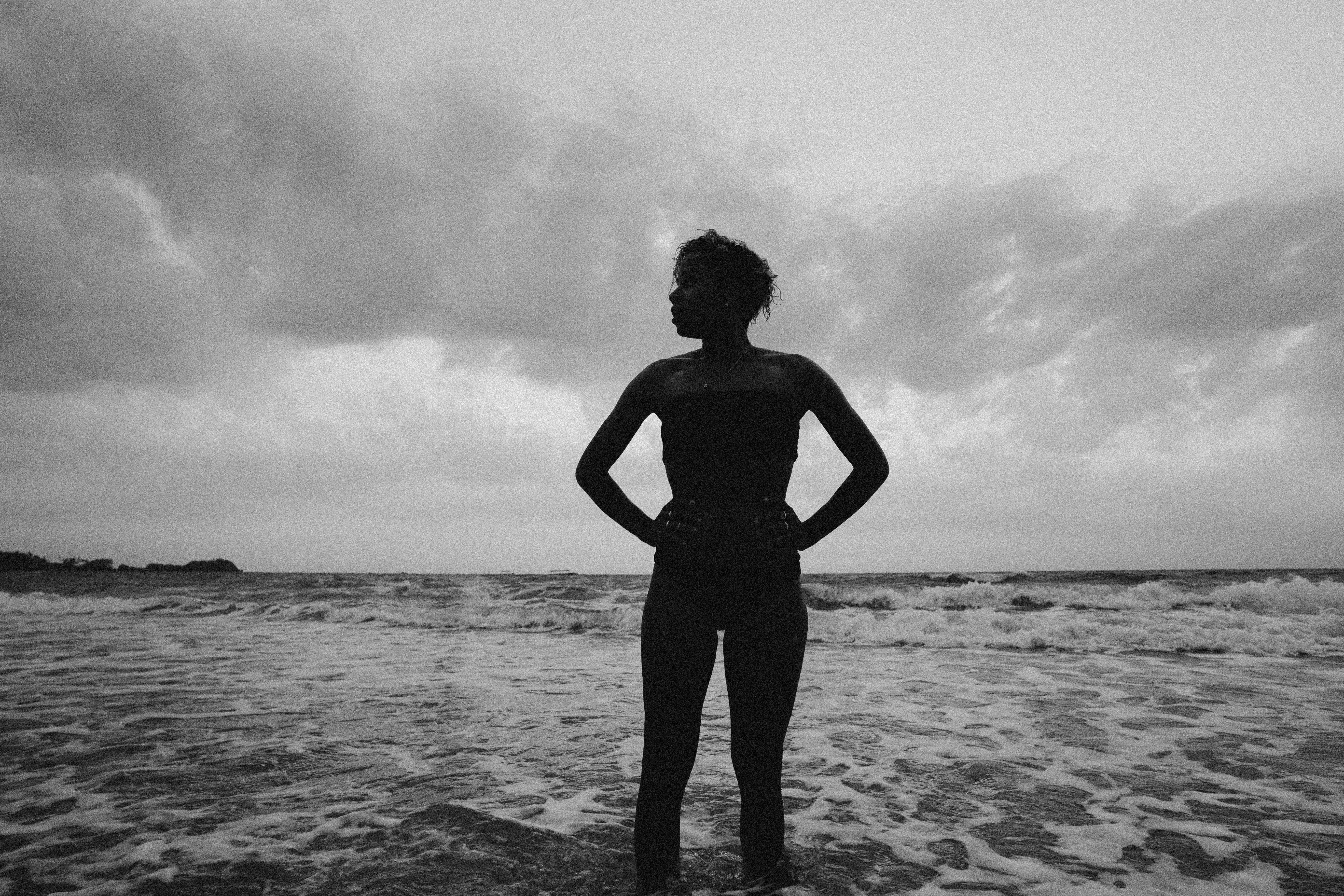 Grayscale Photo of a Woman Wearing Black Top at the Beach · Free Stock ...