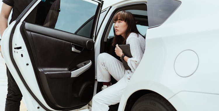 Confident Asian Woman Getting Off Car