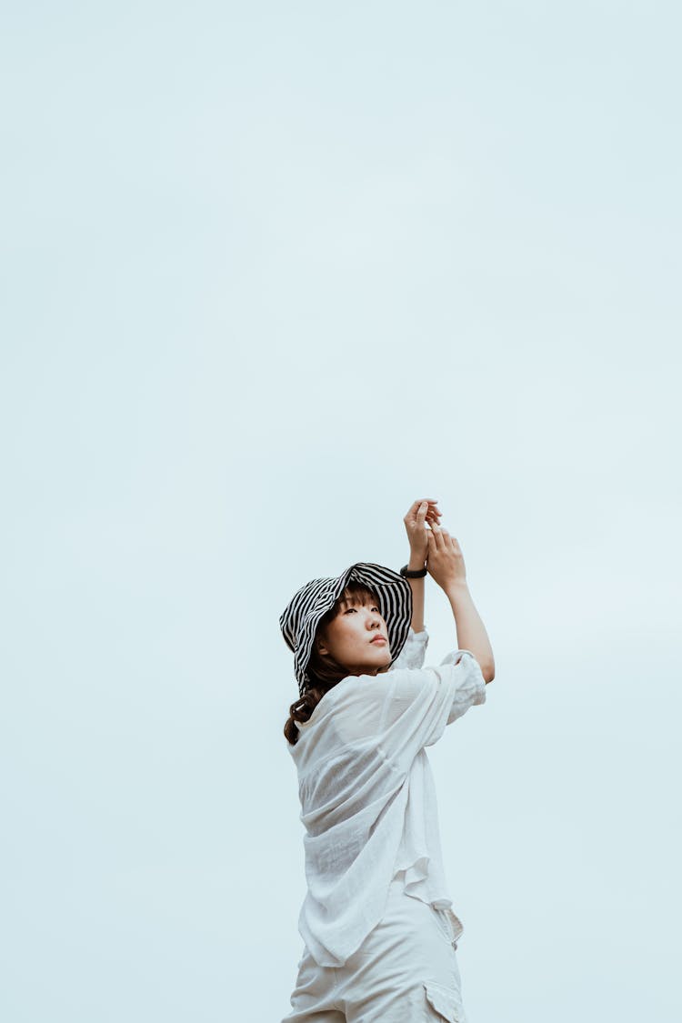 Slim Ponder Asian Model In Hat Standing On Blue Background