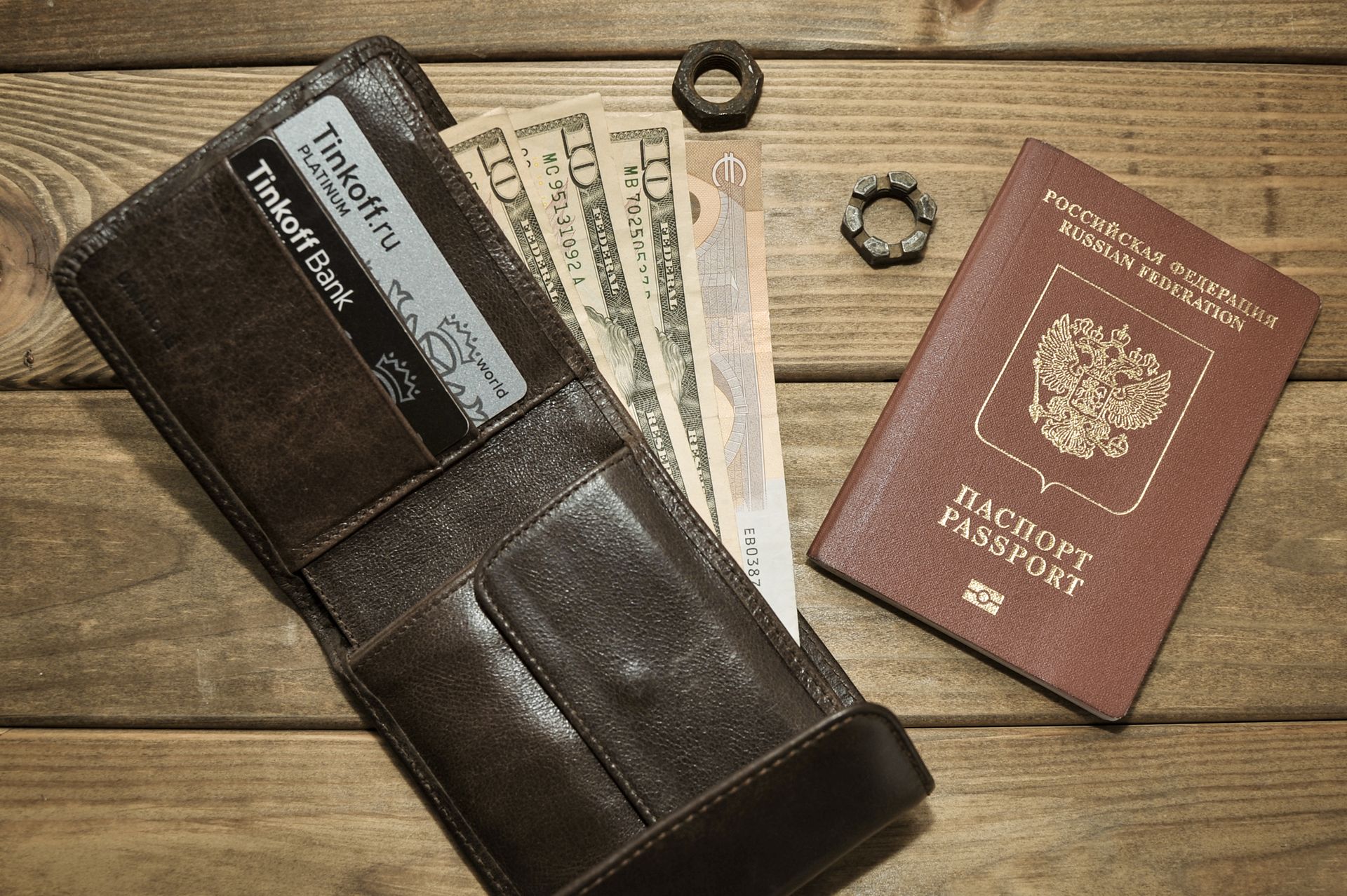 Photograph of a Leather Wallet with Dollar Bills Beside a Passport