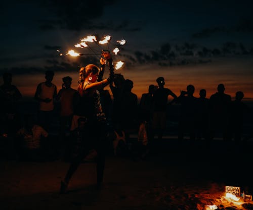 People Standing on Beach during Night Time