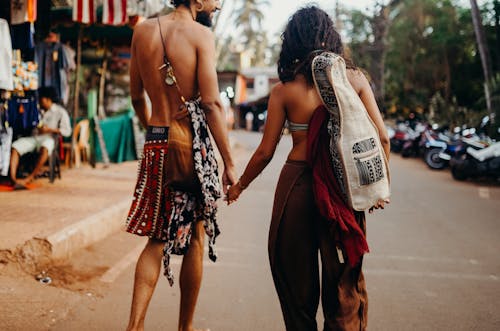 Photo of Couple Walking While Holding Hands