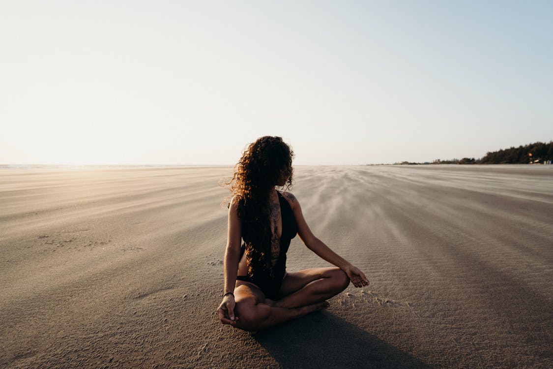 Woman Sitting on Sand