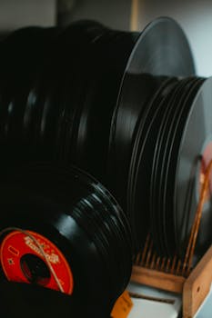 Close-up of assorted vintage vinyl records displayed in a rack, perfect for retro music themes.