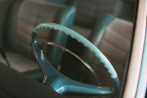 Free Detailed view of a vintage car steering wheel and seat, showcasing classic design. Stock Photo