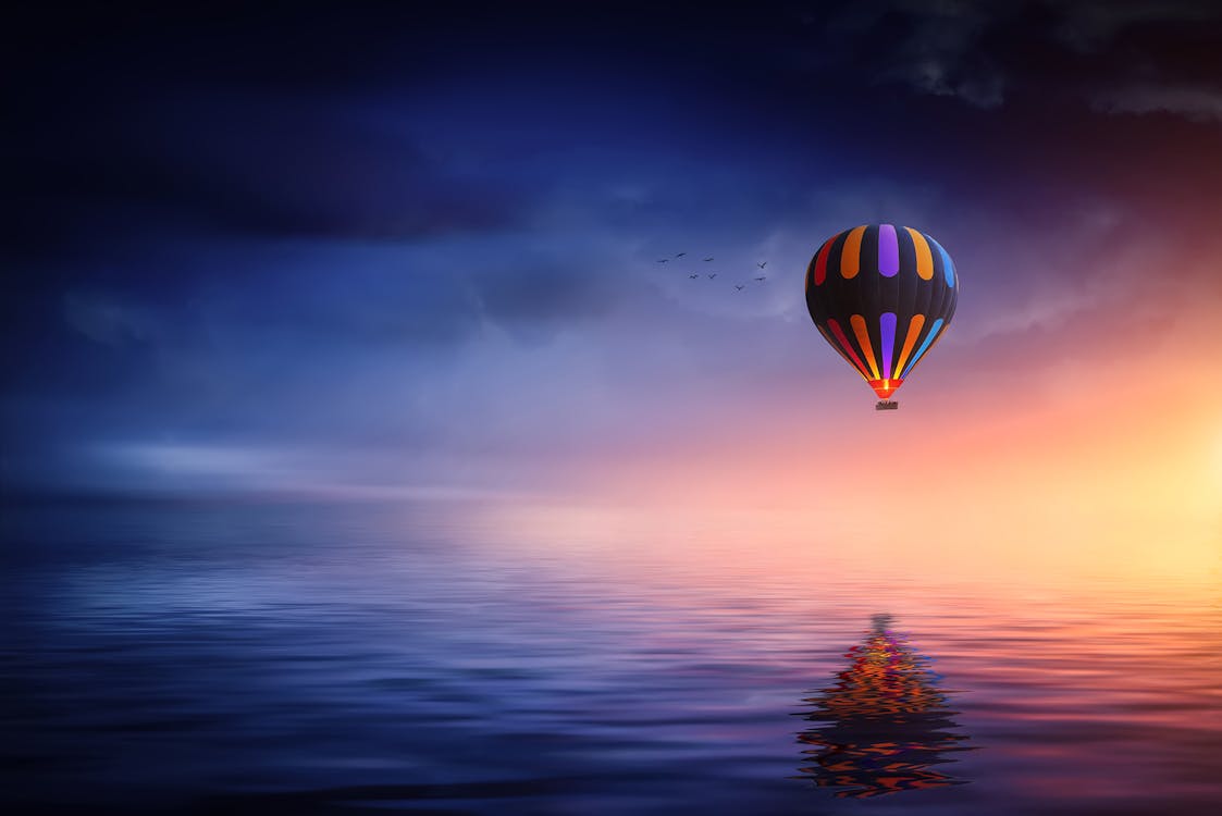 Multicolored Hot Air Balloon over Calm Sea