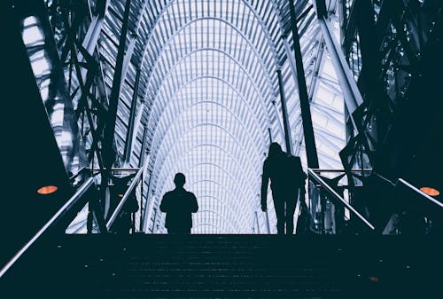 Man and Woman Walking on Stair