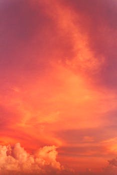 Beautiful orange-hued sunset sky with fluffy clouds over the Philippines.