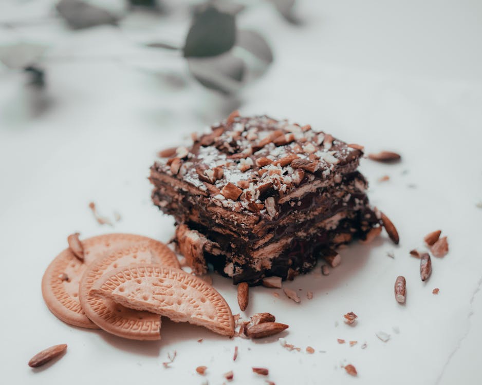 Free Chocolate cake with nuts served with biscuits Stock Photo