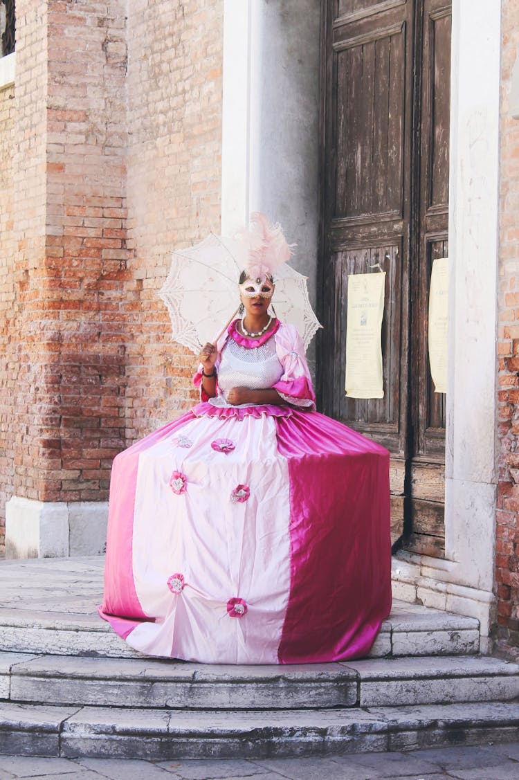 Anonymous Woman Standing Near Old Building In Traditional Costume During Carnival