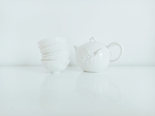 Free Set of white porcelain bowls on table with teapot Stock Photo
