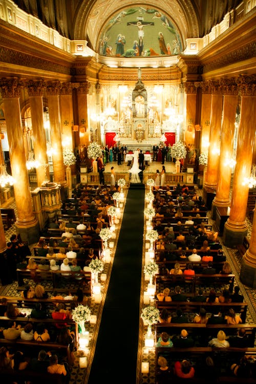 People Sitting on Chairs Inside Church