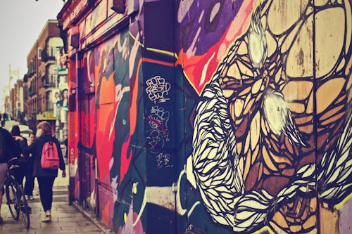 Walking Woman Beside Graffiti Art