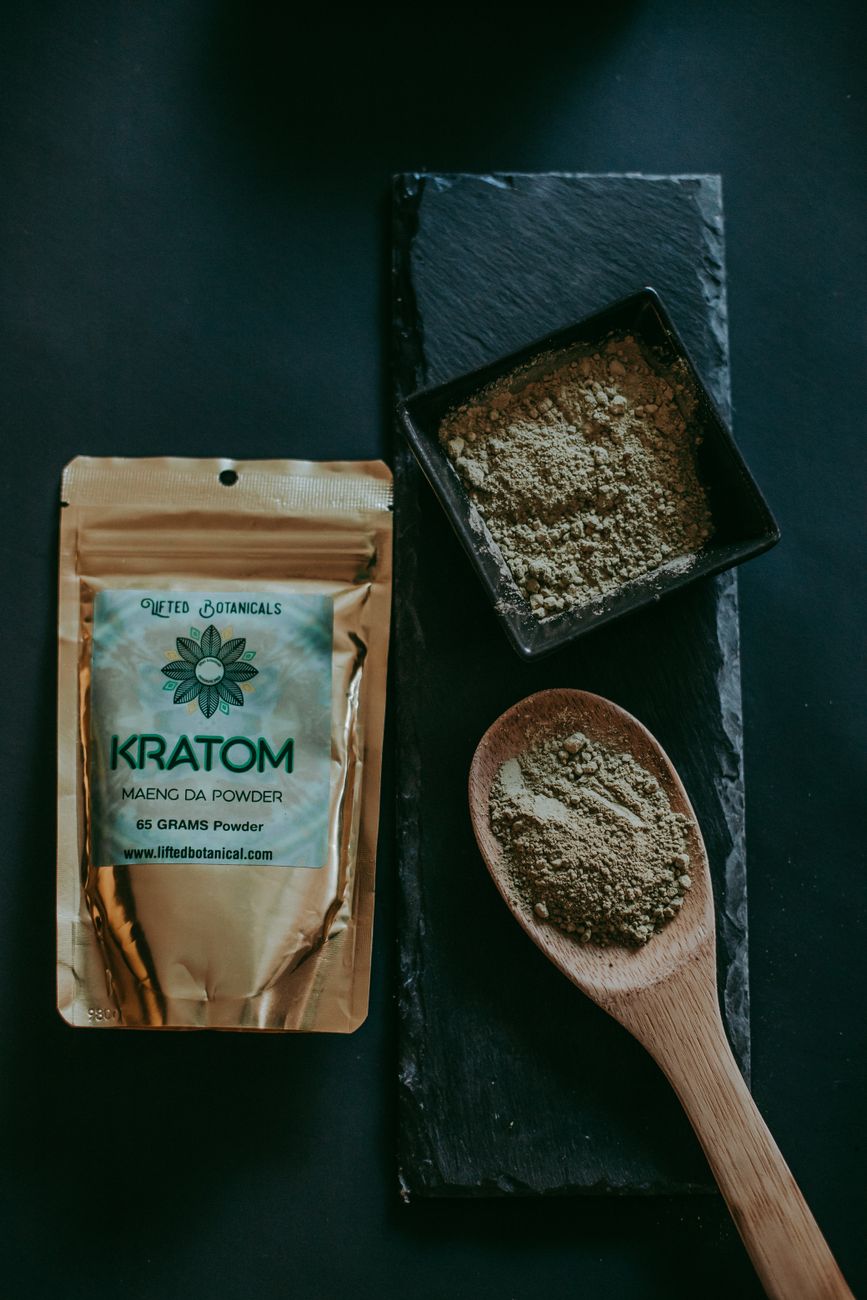 A package of kratom maeng da powder alongside loose powder, the type of product sold by the Oxford shop.
