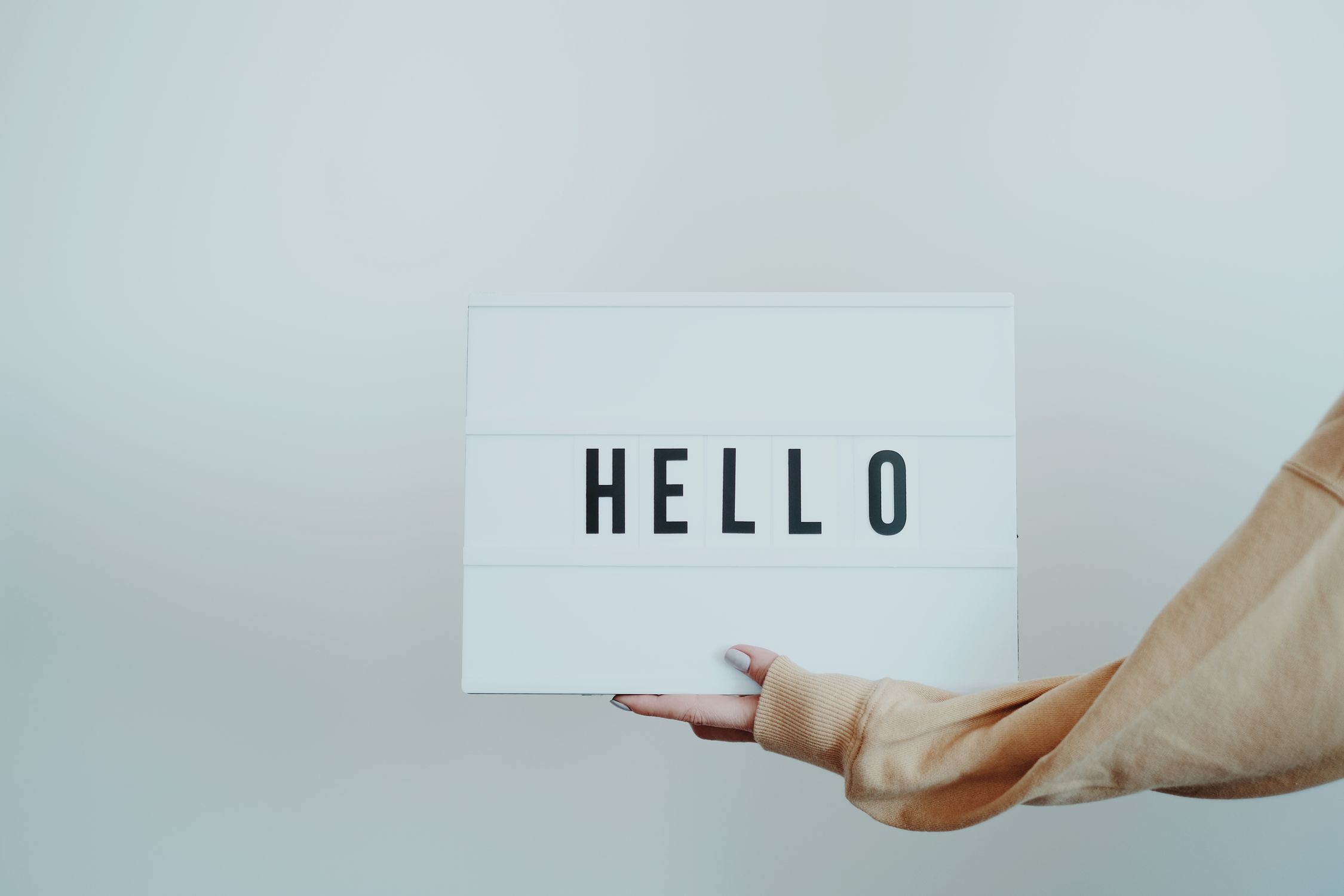 Hello Hello. Sign Person Holding a Hello Sign · Free Stock Photo