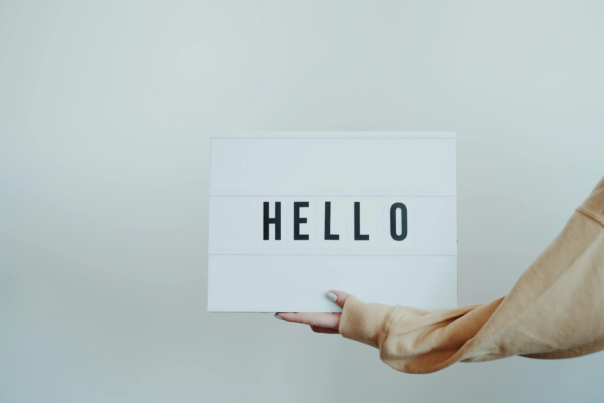 Person Holding a Hello Sign