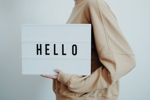 Free Person Wearing Sweater Holding a Sign Stock Photo