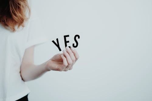 Woman Holding a Yes Sign