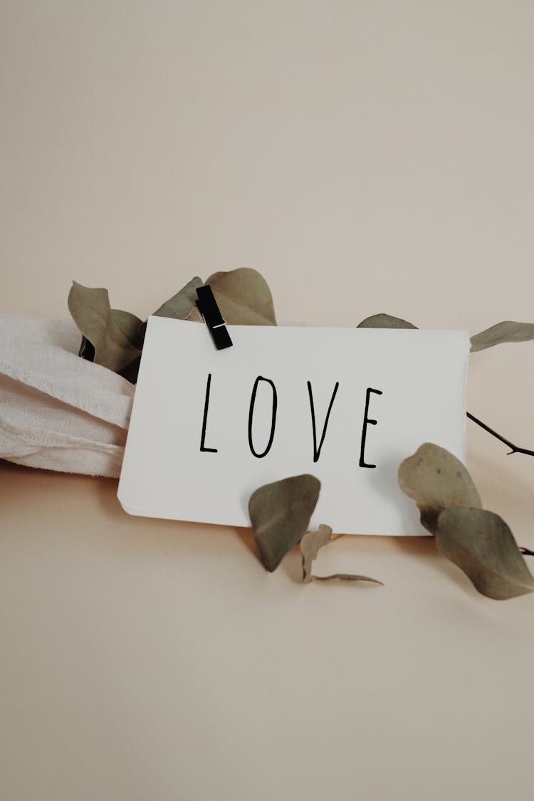 Word Love Written On White Paper